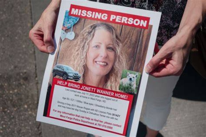 a person holds a missing persons flier of Sierra Stevens