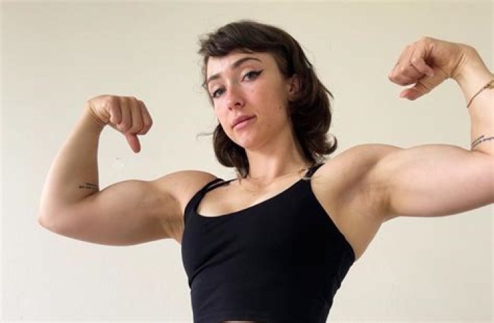 Lean Beef Patty flexing her bicep